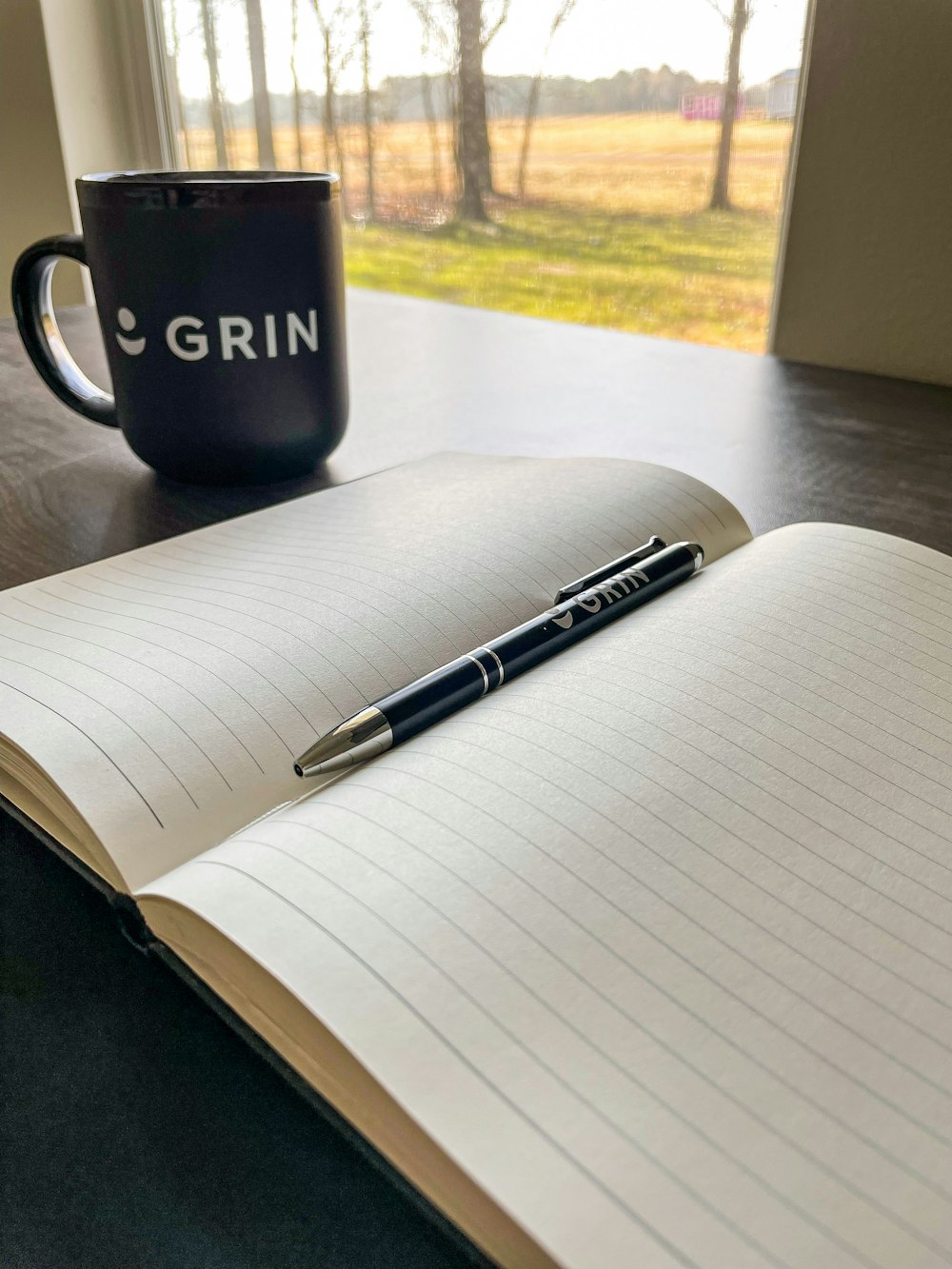 a pen and a cup on a table
