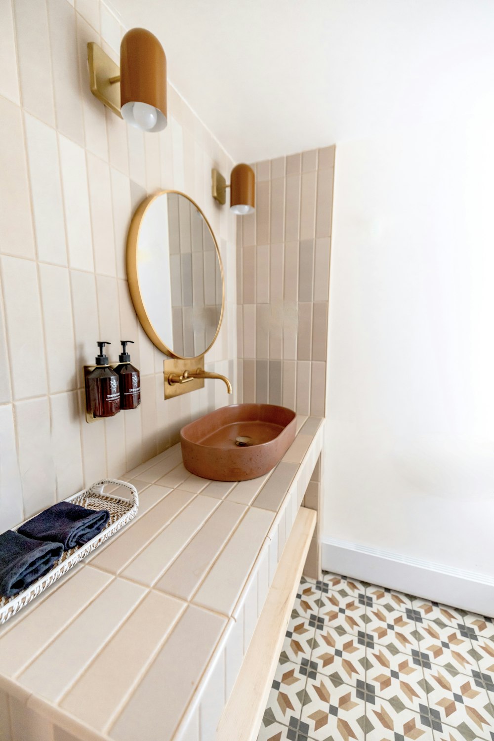 a bathroom with a round mirror