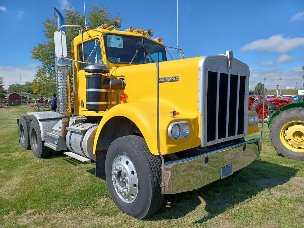 a yellow truck on the grass