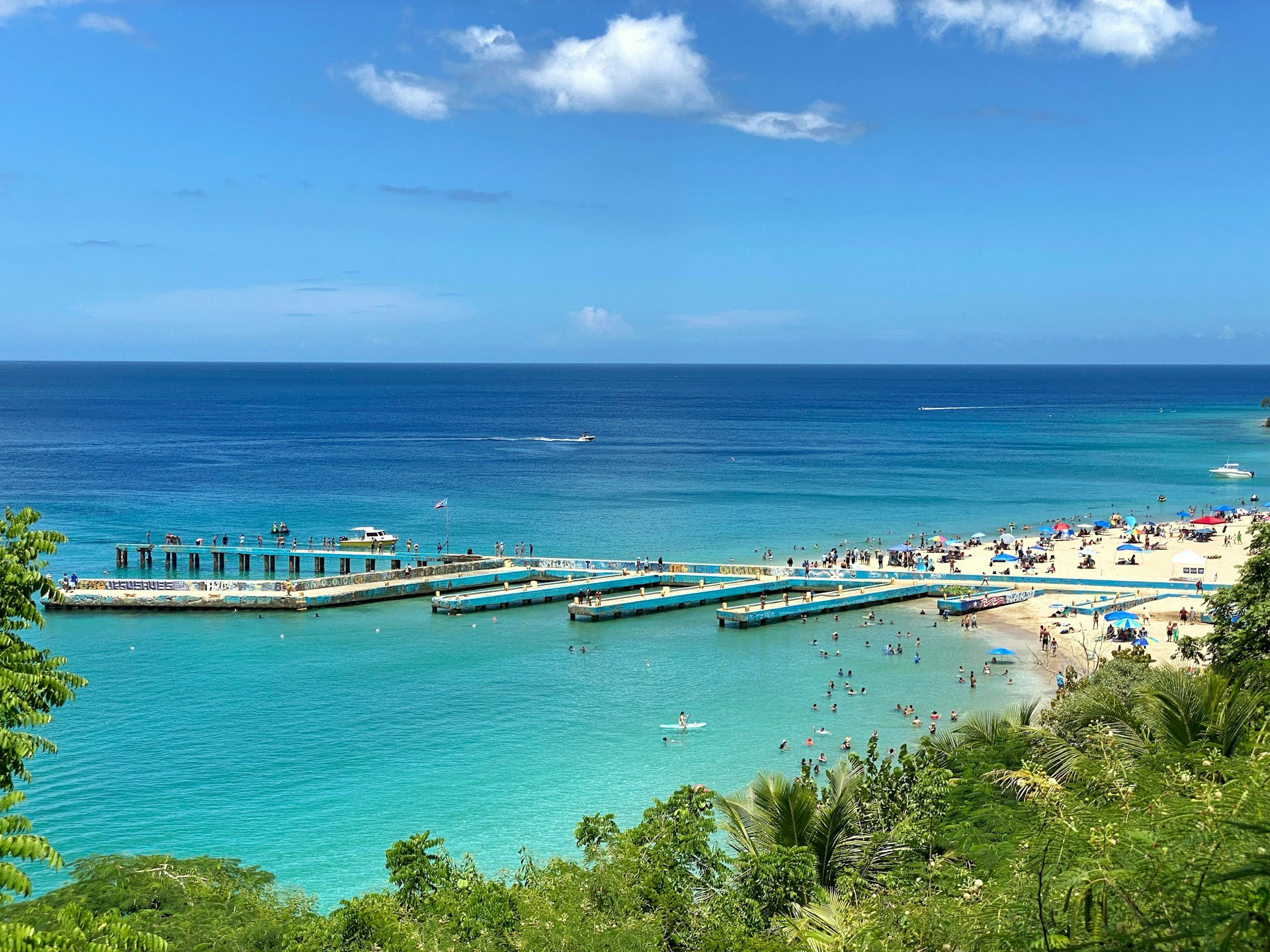 a beach with a pier and boats