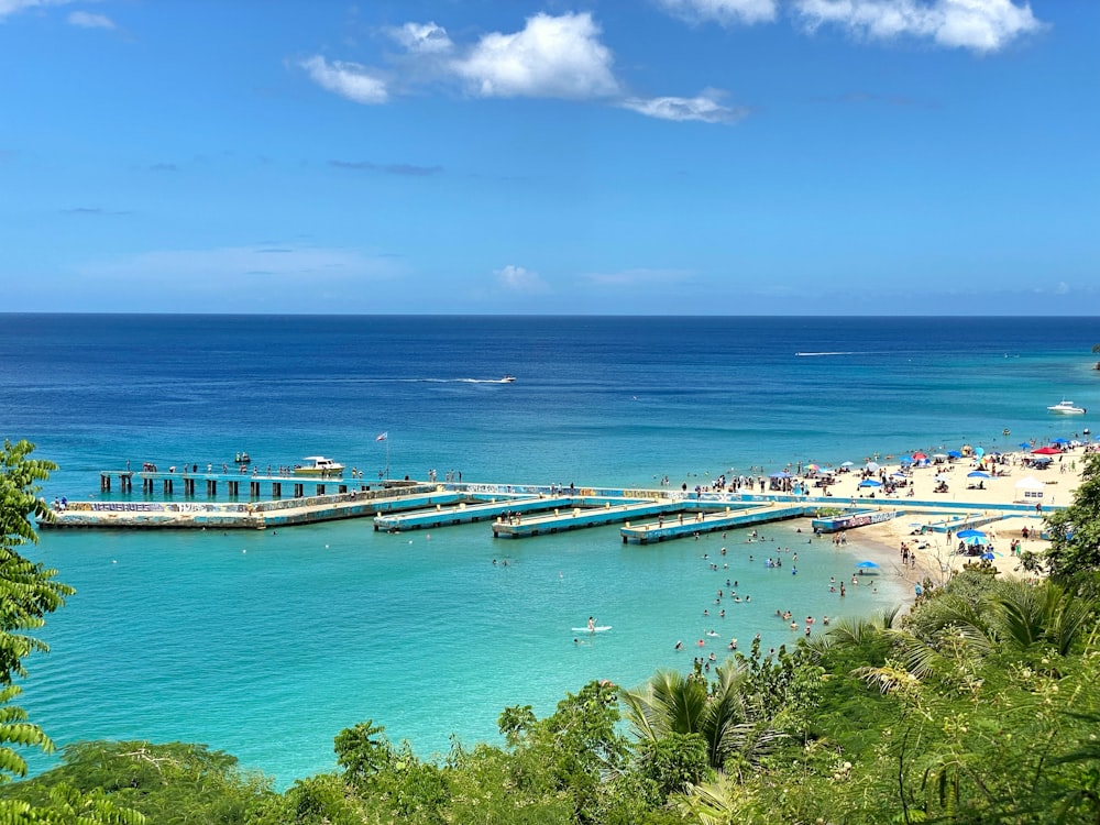 a beach with a pier and boats