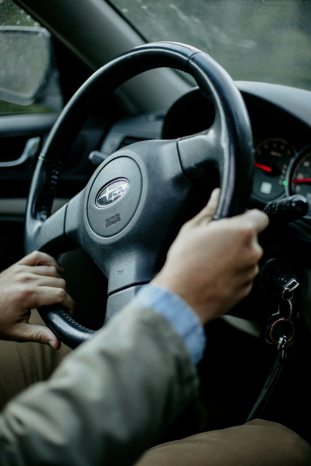 a person holding a steering wheel