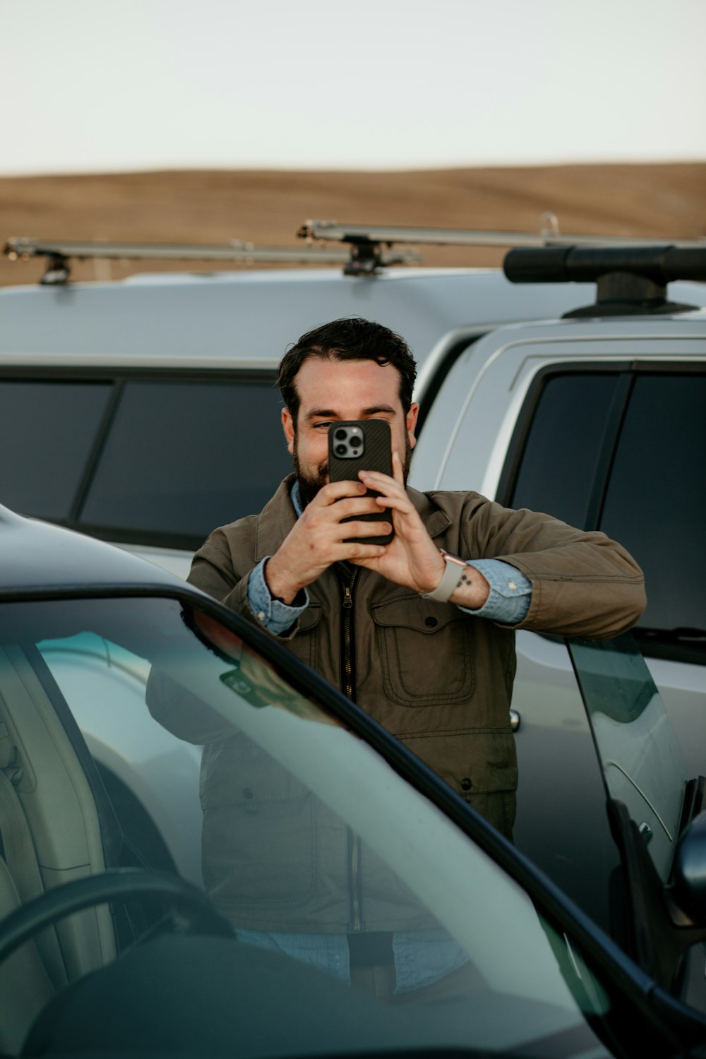 a man taking a picture of himself in a car