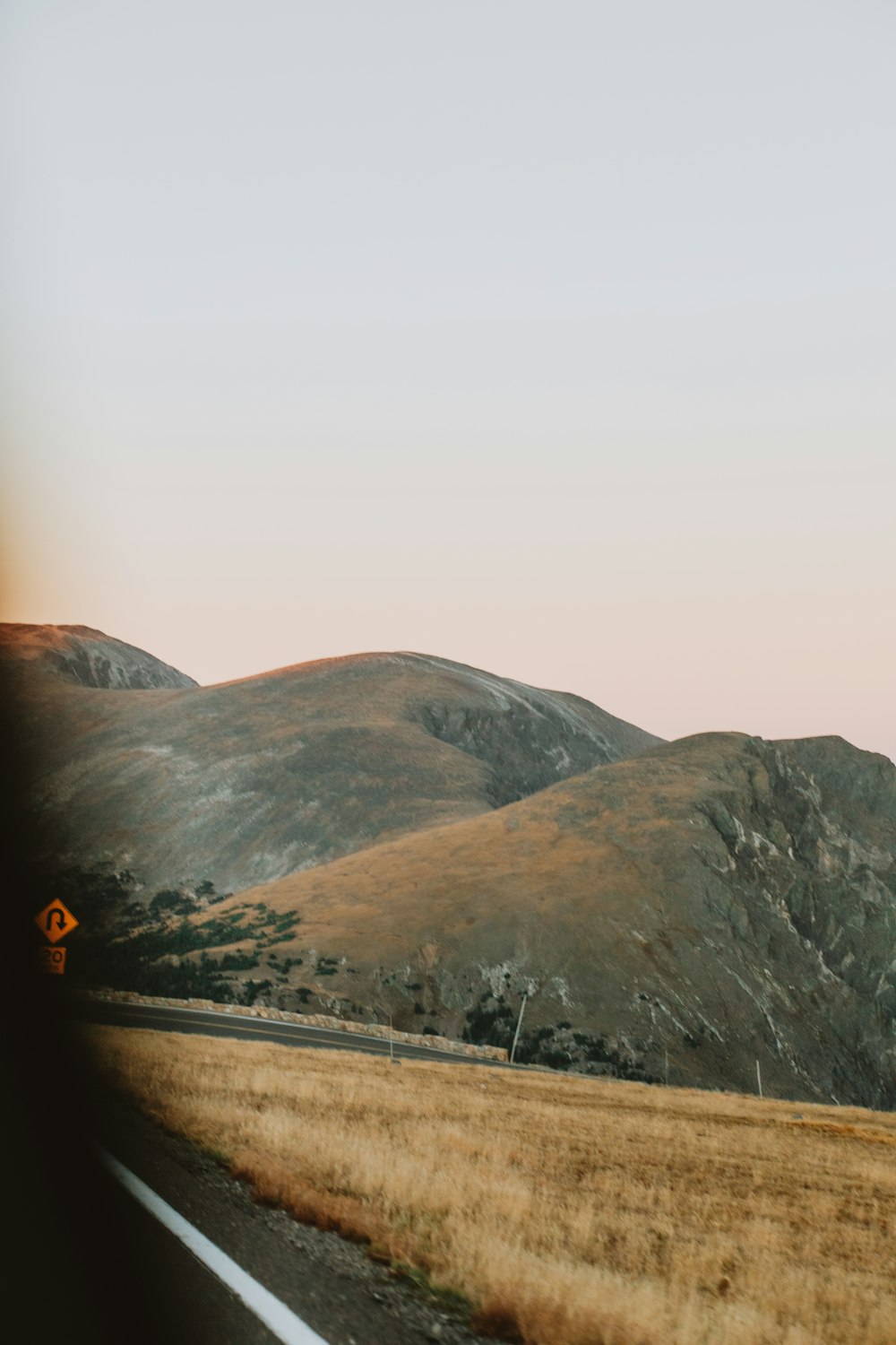 a road with a mountain in the background