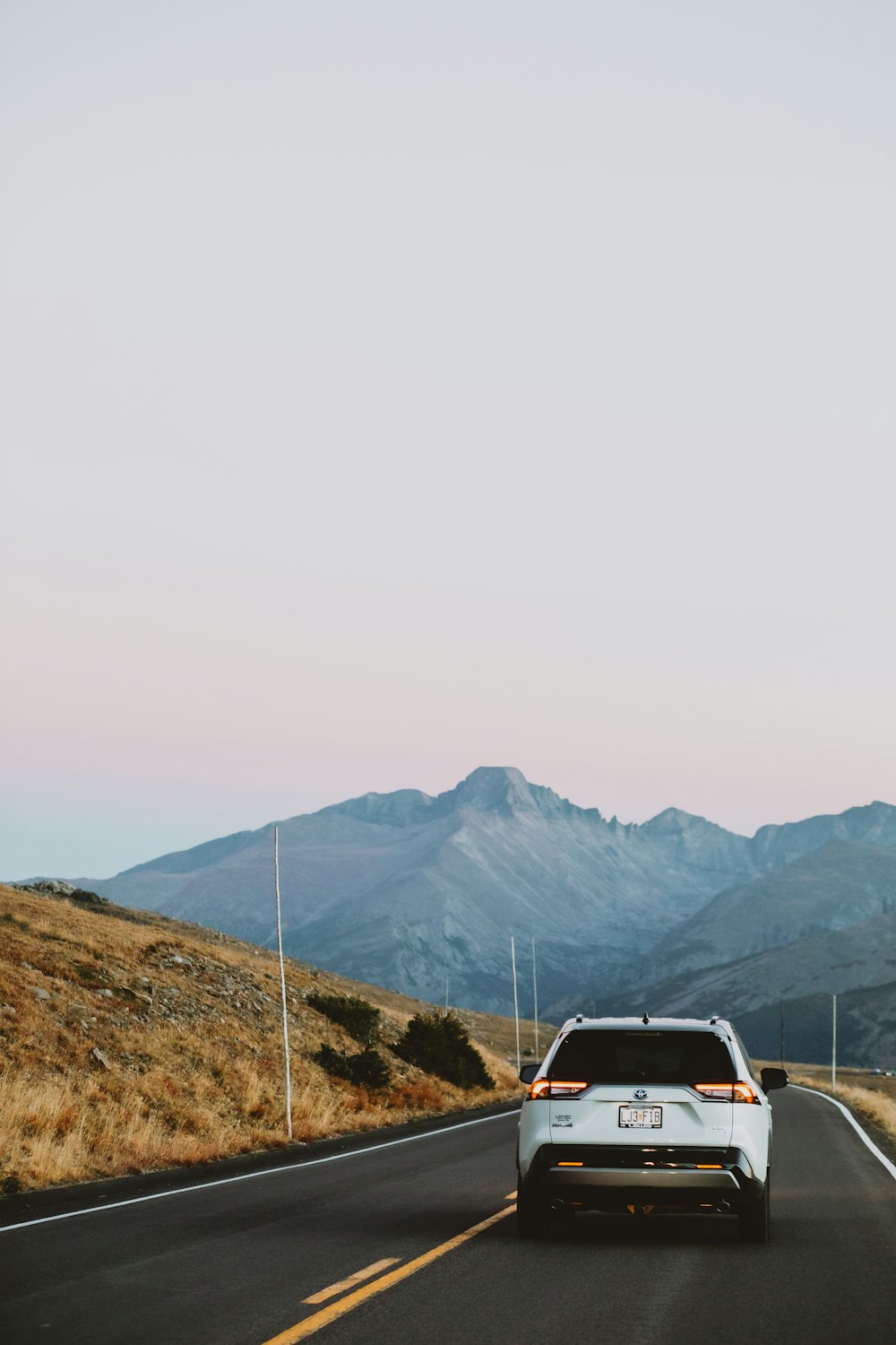 a white car driving on a road