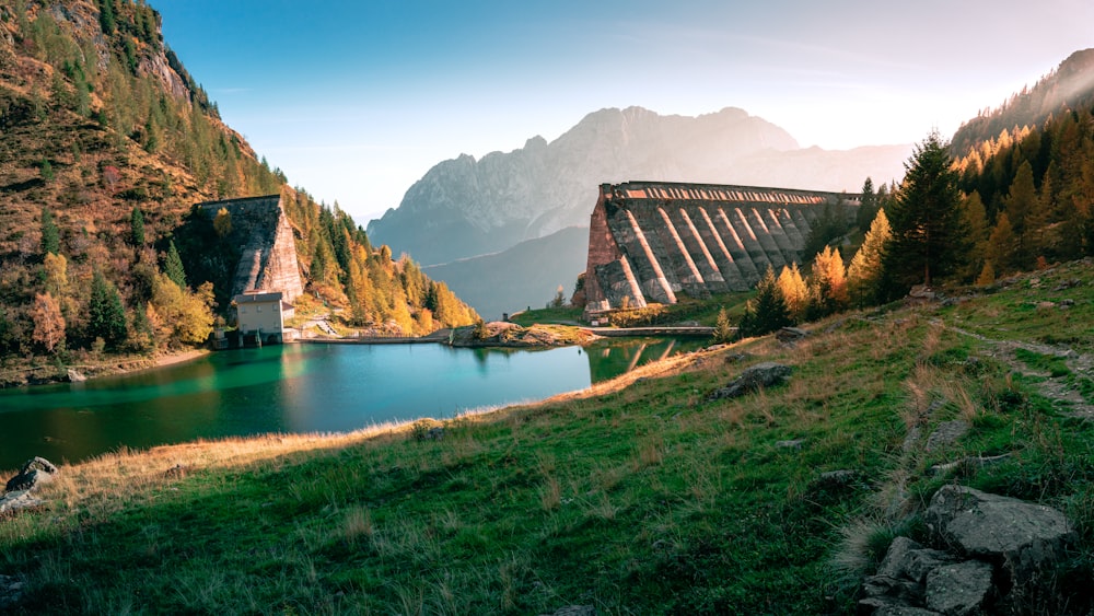 a building on a hill by a lake