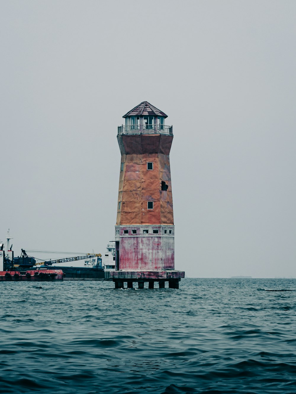 a lighthouse in the middle of the ocean