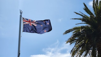 a New Zealand flag on a pole