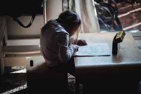 a person writing on a table