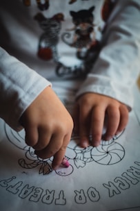 A cheerful child coloring a vibrant animal-themed page with crayons.