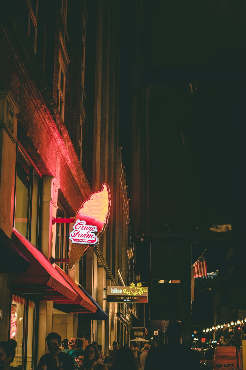 a large red sign hangs from a building