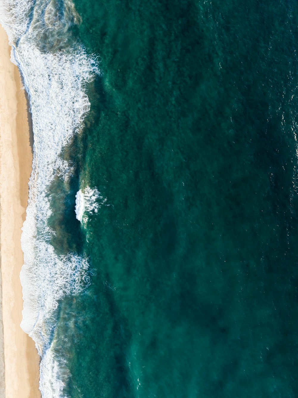 a body of water with a rock in the middle