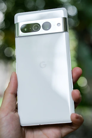 Close-up of a hand effortlessly navigating a sleek Android device with a glowing mint green interface.