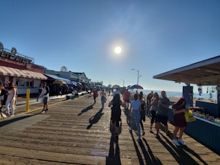 Casual summer outfits displayed on a sunny boardwalk with ocean views