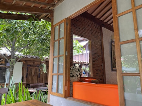 A cozy veranda with glass sliding walls, perfect for all seasons.