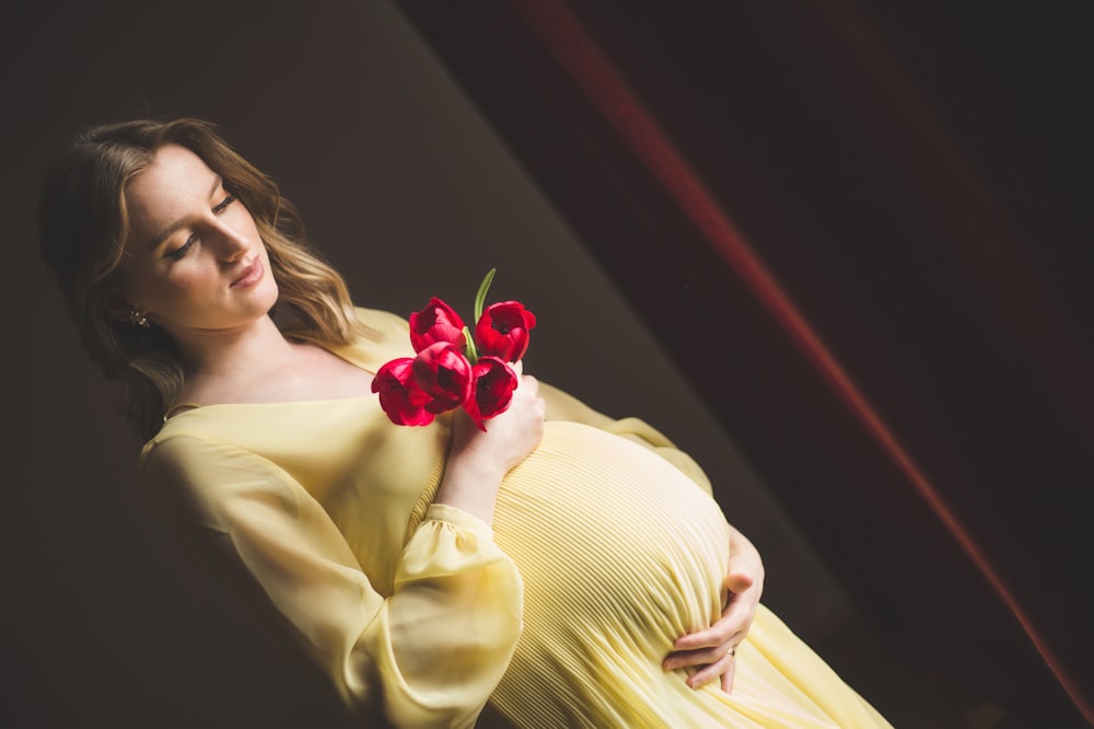 a woman holding a red rose