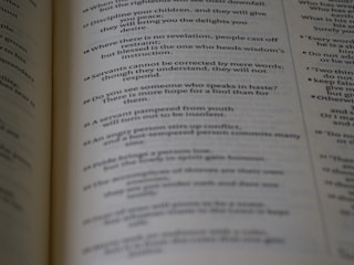 Close-up of an open book with clean, serif font on cream paper.