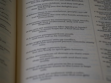 Close-up of an open book with crisp serif font text on cream-colored pages.