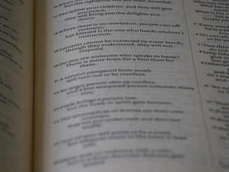 Close-up of an open book with crisp serif font text on cream-colored pages.