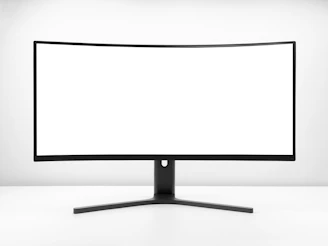 a white monitor with a black stand
