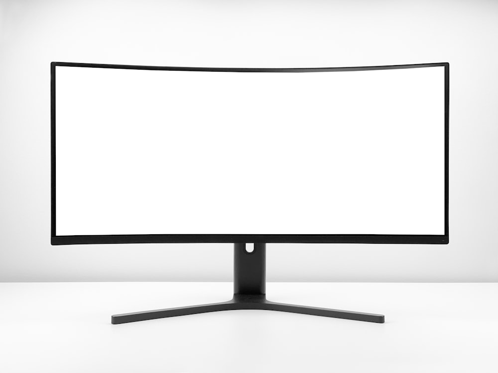 a white monitor with a black stand