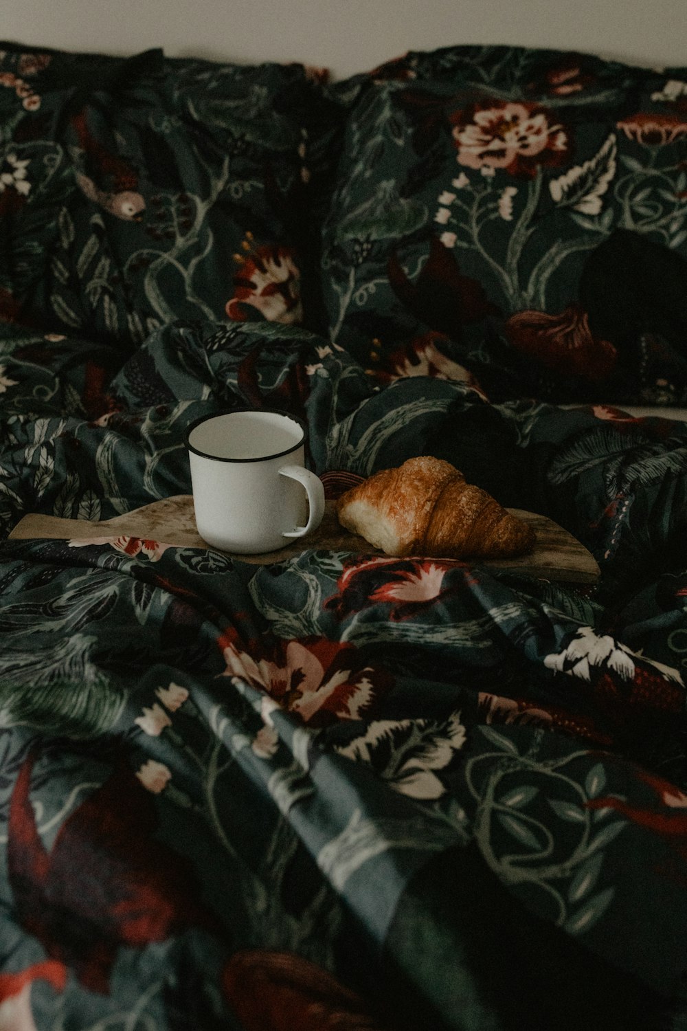 a cup of coffee on a bed