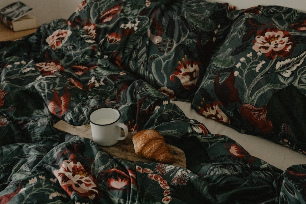 a cup of coffee on a bed