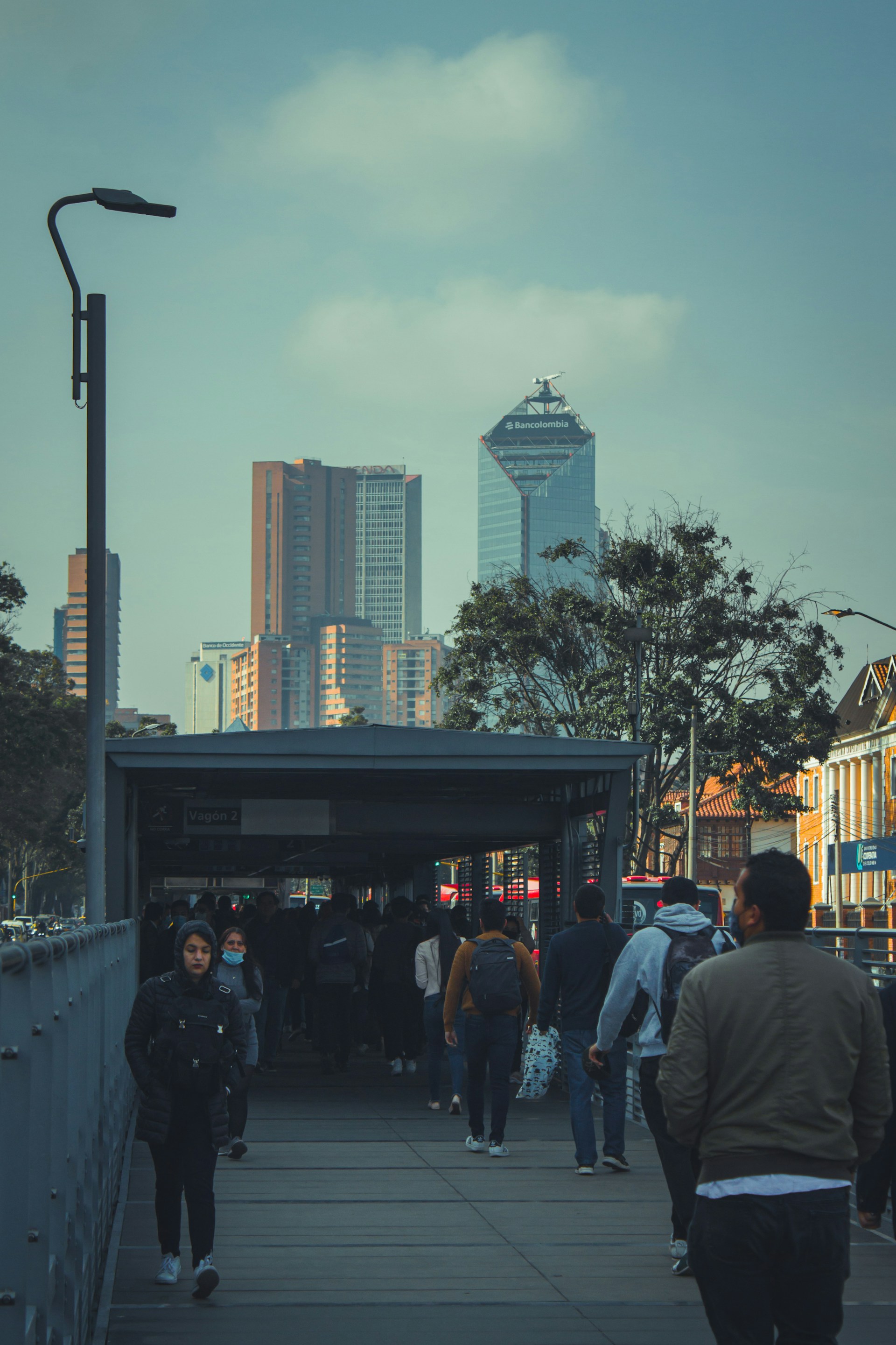 a group of people walking on a sidewalk