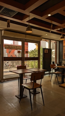 Warm interior of 24 Dreams Cafe with wooden tables and Thai-inspired decor.