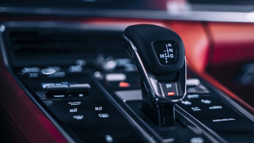 a black cell phone on a black dashboard