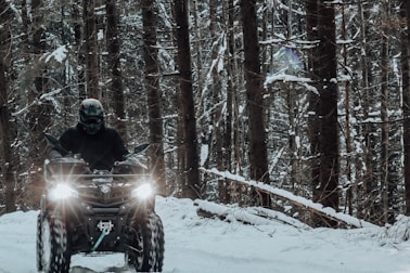 a man riding a motorcycle in the snow