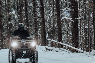 a man riding a motorcycle in the snow