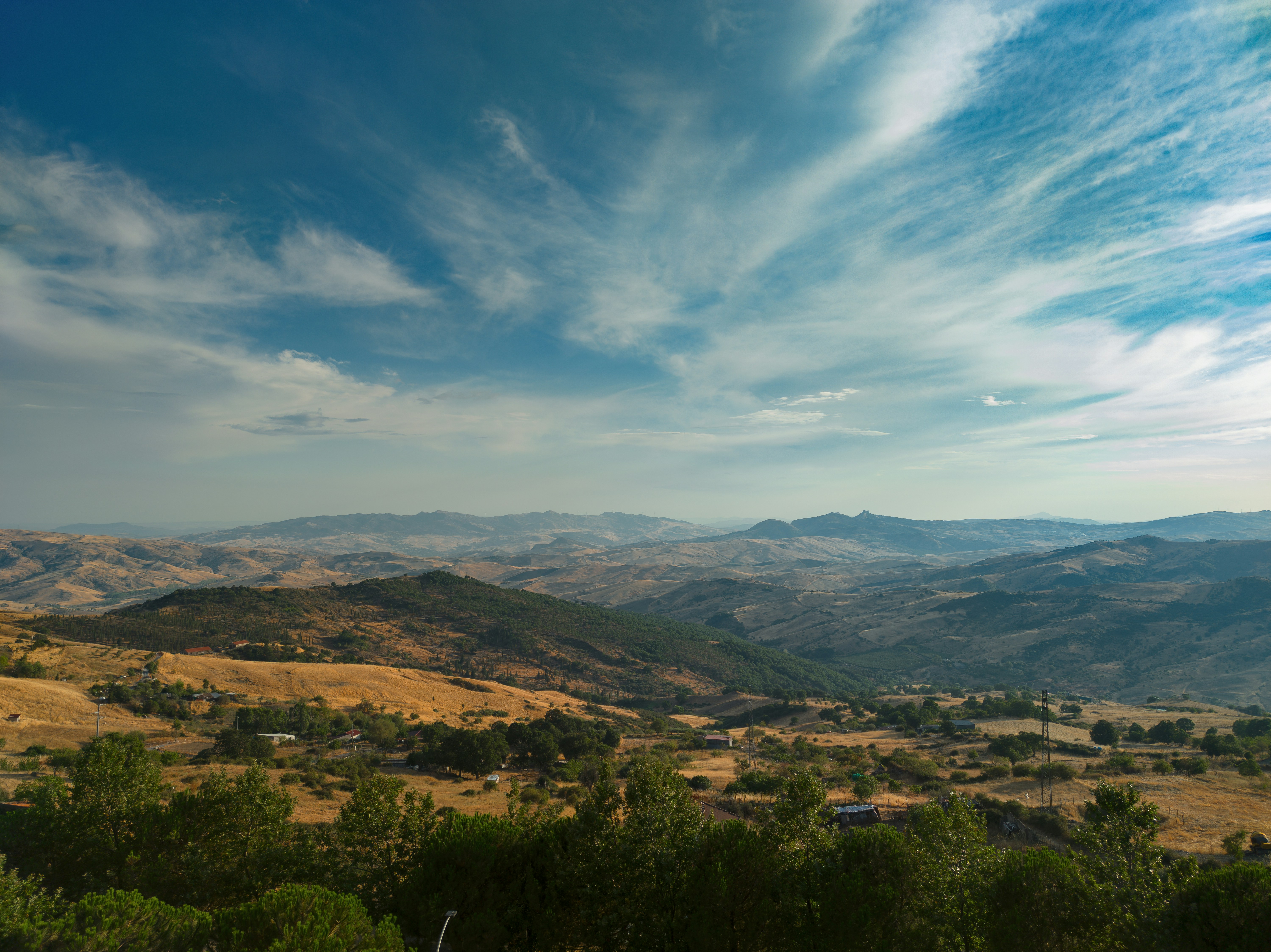 a landscape with trees and hills, 