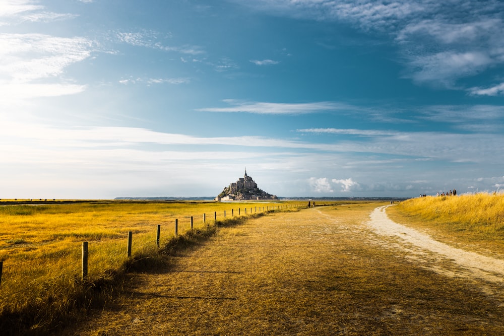 a dirt road leading to a mountain