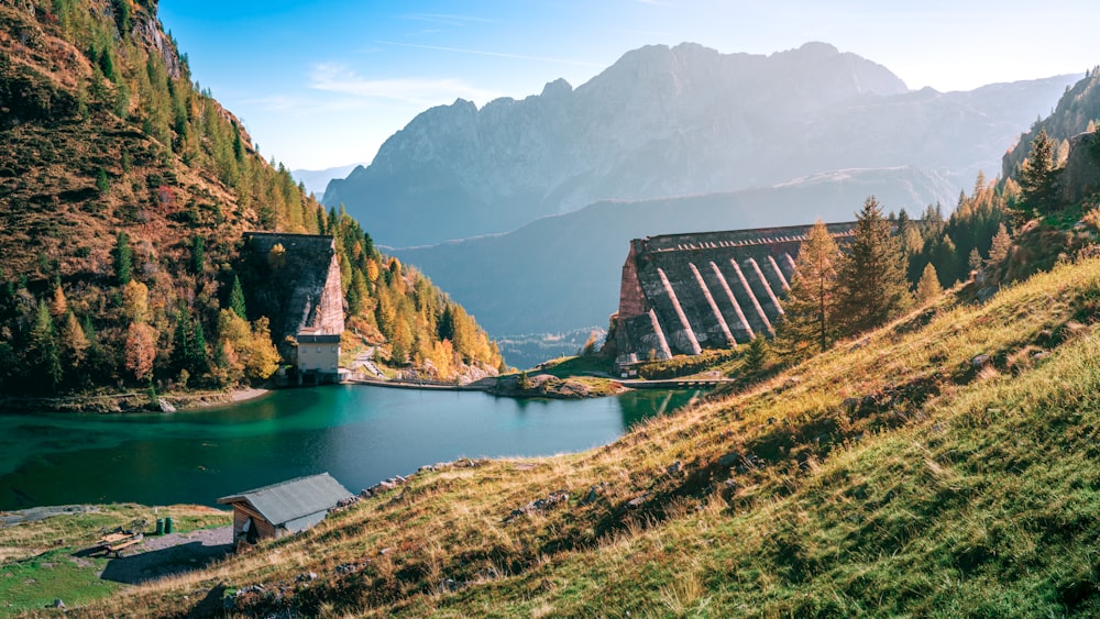 a building on a hill by a lake