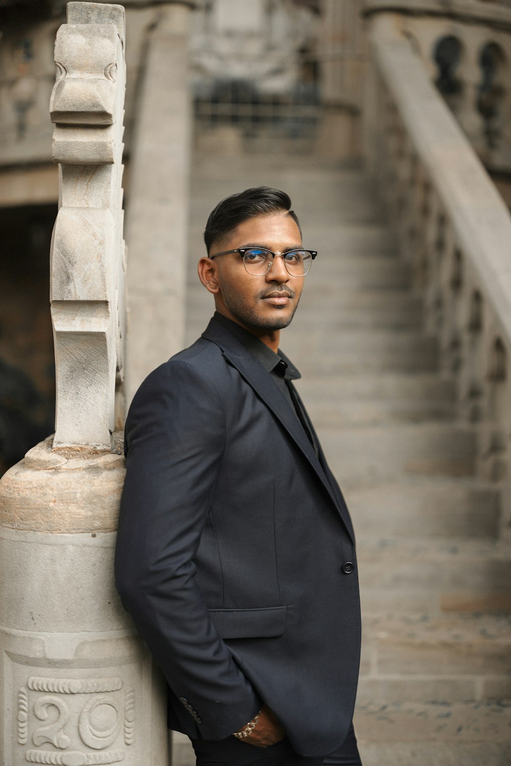 a man in a suit standing in front of a building