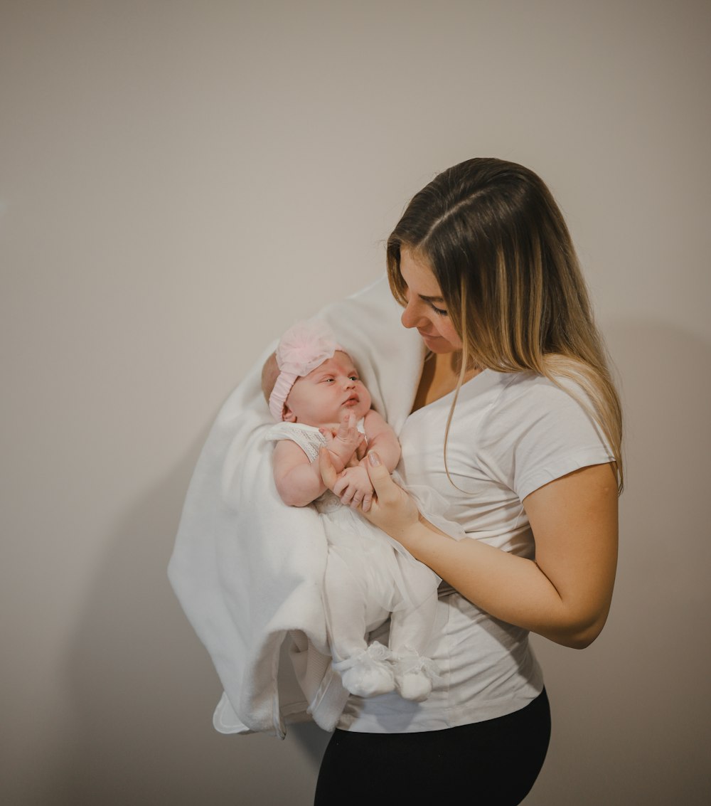 a woman holding a baby