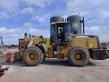 Yellow septic tank made of durable plastic placed on construction site.