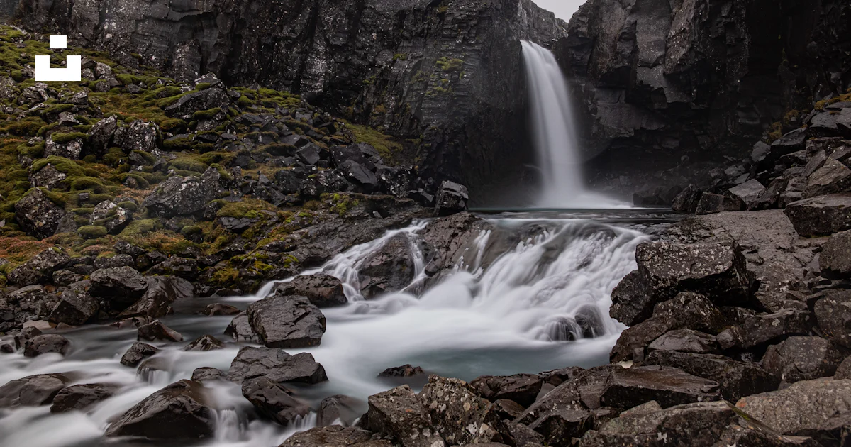 Waterfall Through Rocks A waterfall over rocks photo – Free Water Image on Unsplash