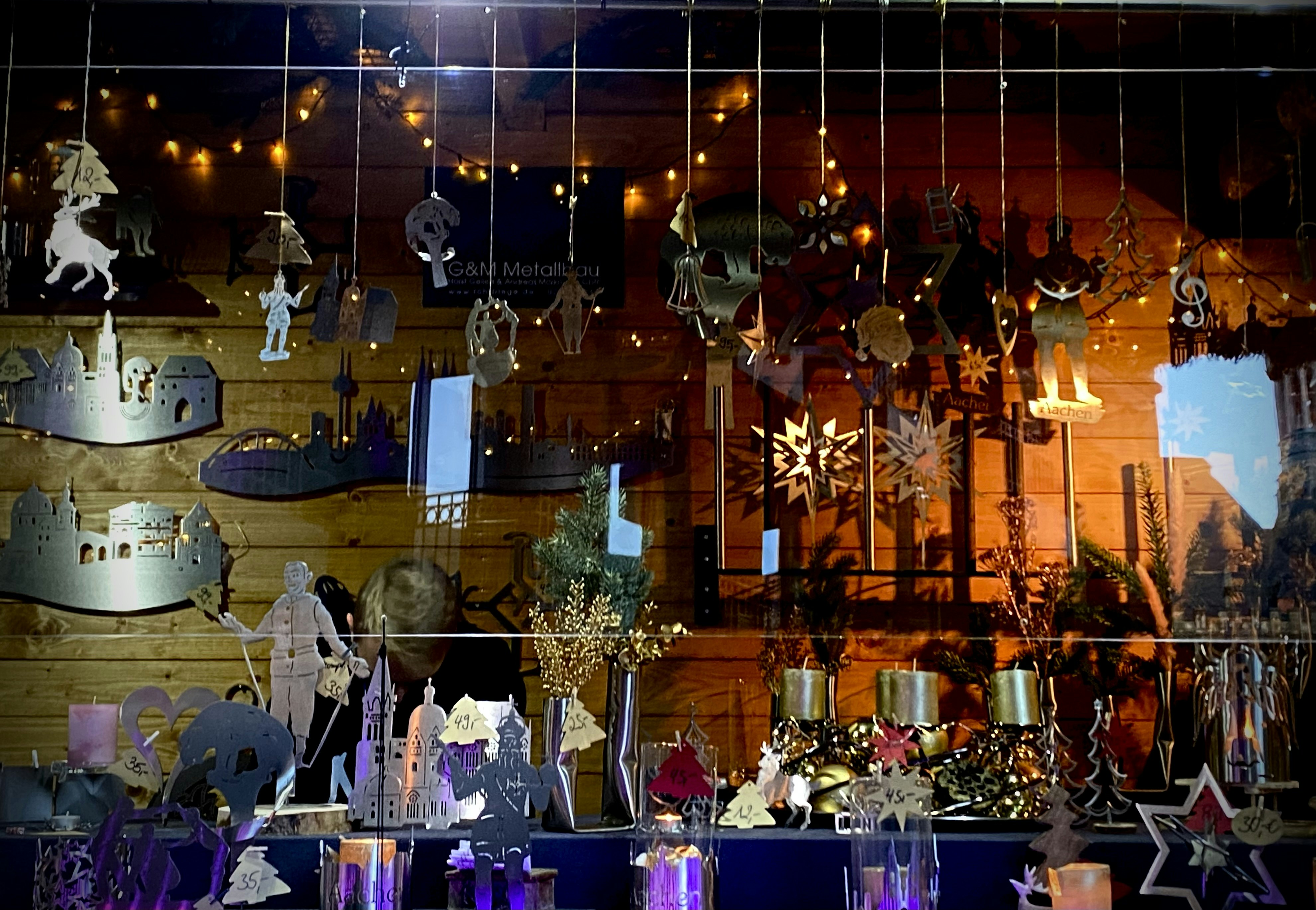 Modern metal ball holder displayed in a shop setting with warm lighting.