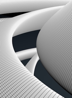 Abstract, futuristic structures composed of interwoven, curved forms with a grid-like pattern covering their surface. The design suggests a looped, flowing architecture with a focus on repetitive, geometric motifs.