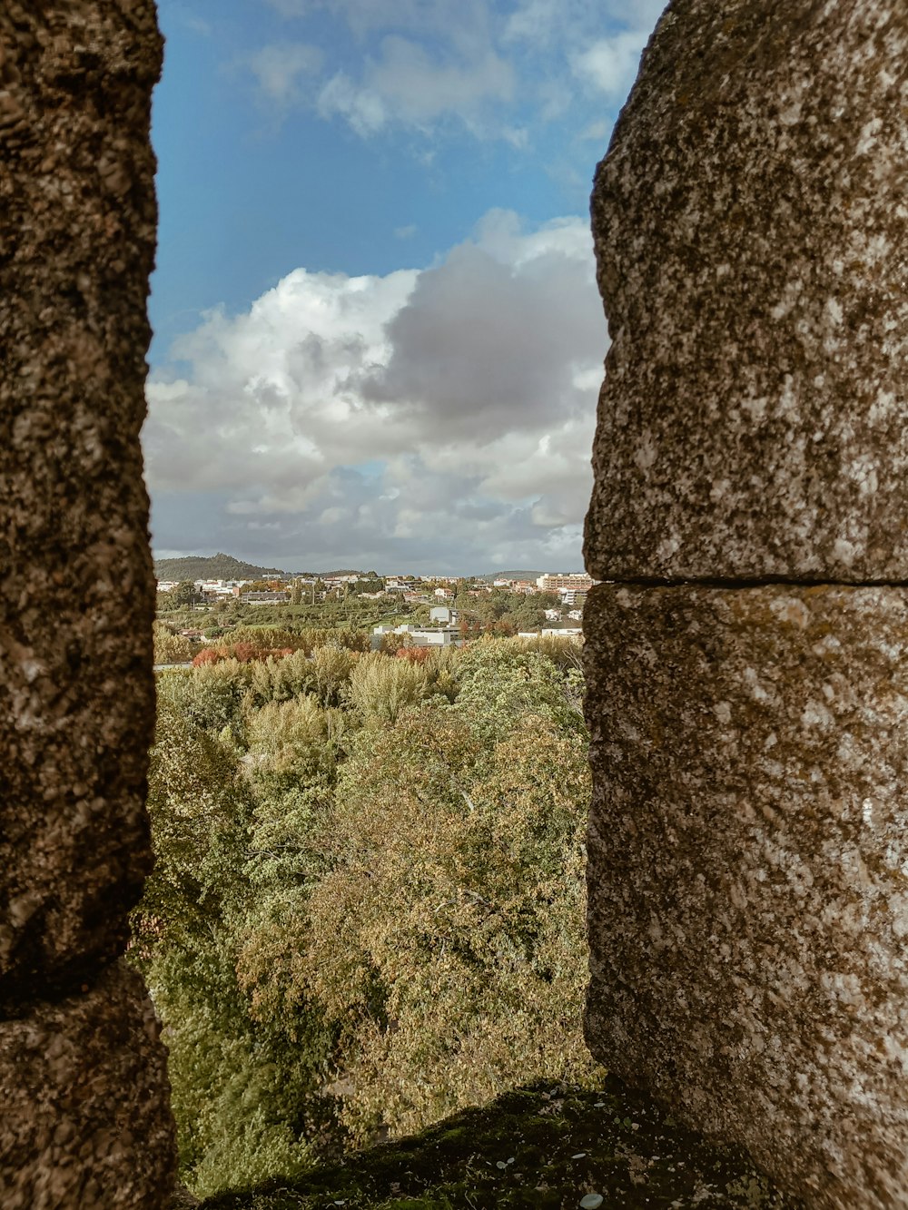 a view of a city from a stone wall