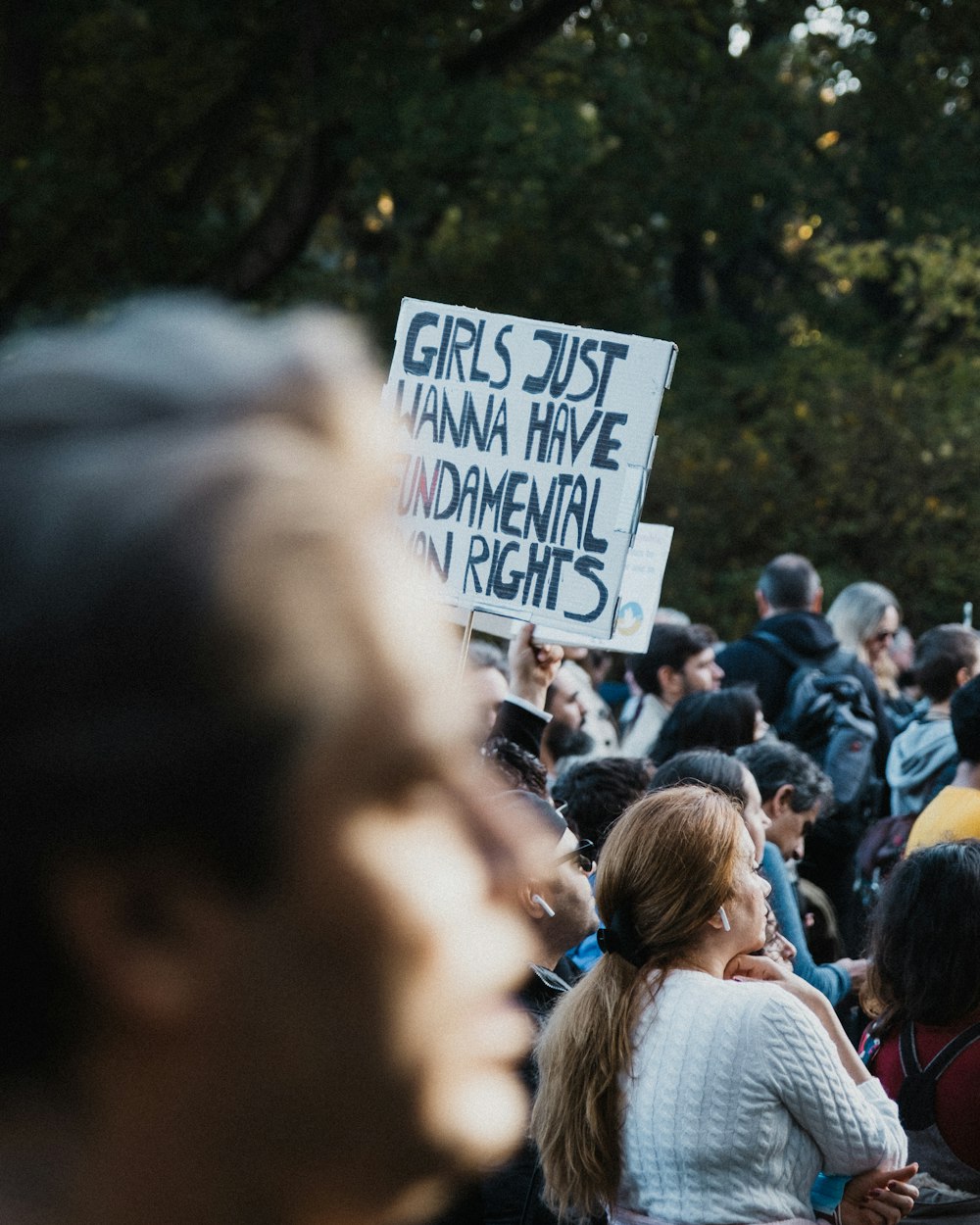 a group of people holding a sign