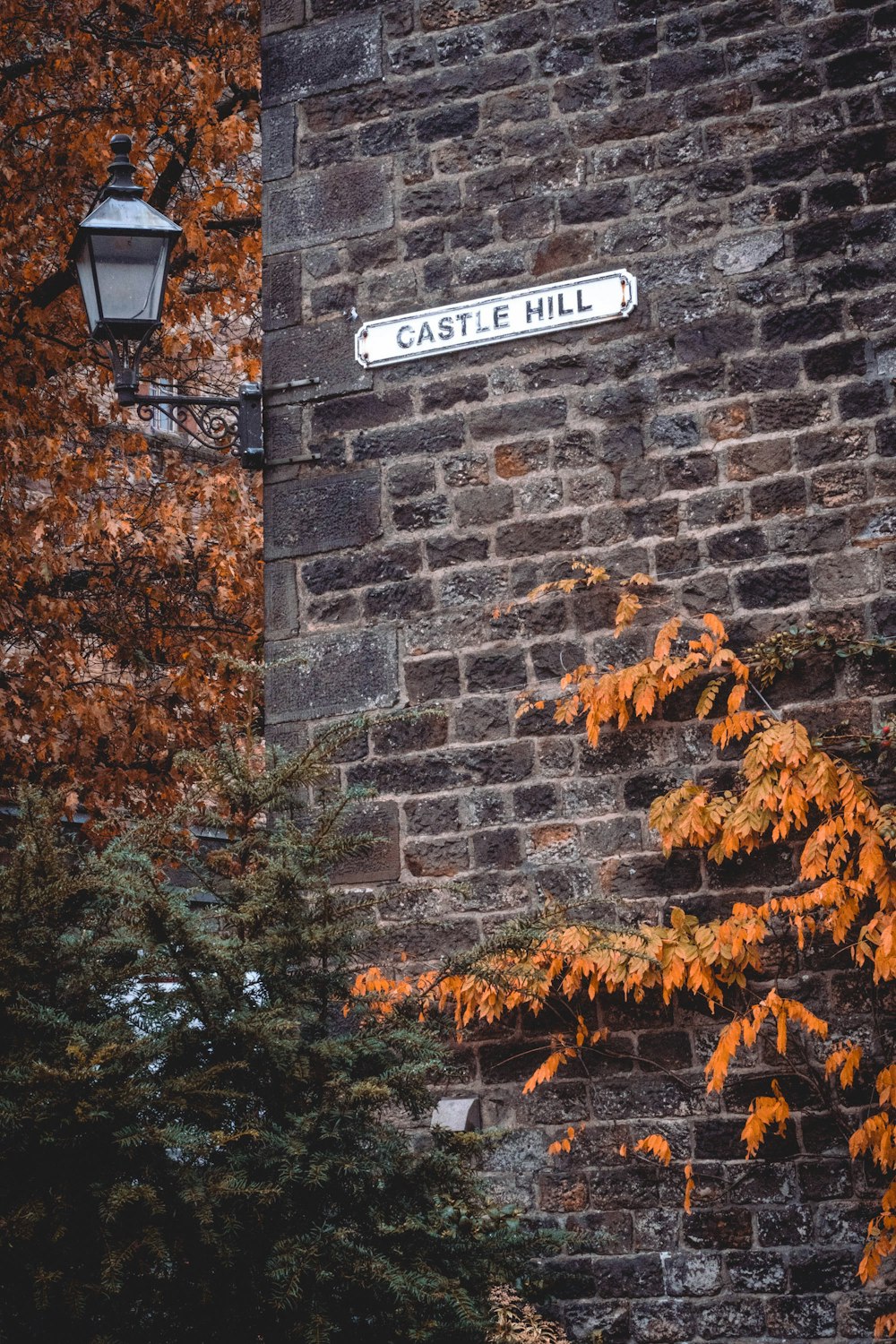 a street sign on a brick wall