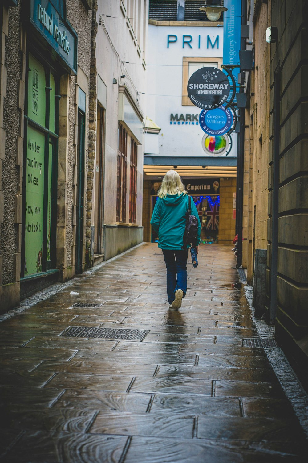 a person walking down a wet street