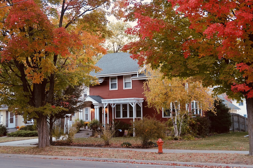 a red house with trees around it