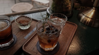 A selection of traditional drinks served in rustic glasses.