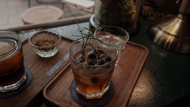 A selection of traditional drinks served in rustic glasses.