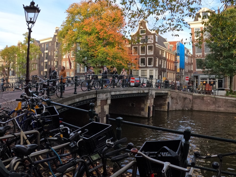 a group of bicycles parked on a bridge over a river