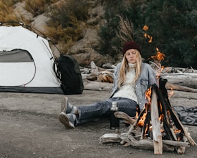 a person sitting next to a campfire